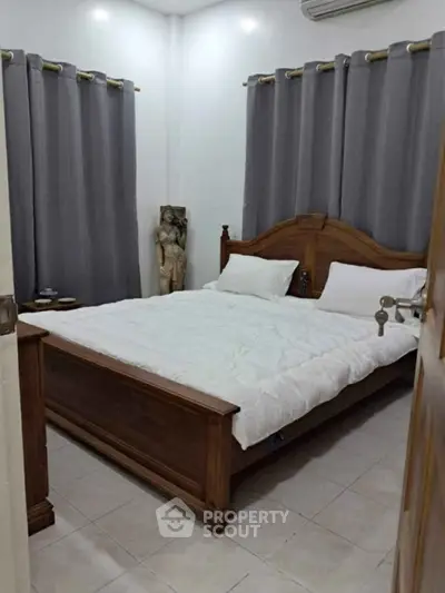 Cozy bedroom with wooden bed frame and elegant gray curtains