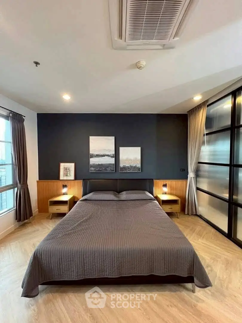 Modern bedroom with stylish decor and large windows for natural light