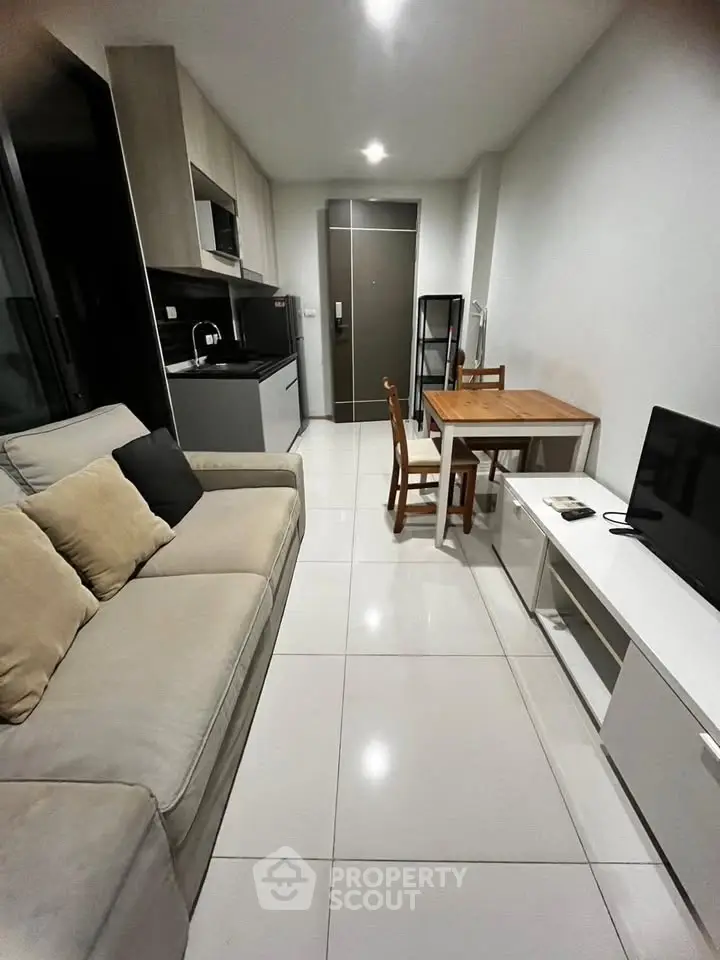 Modern compact living room with open kitchen in sleek apartment