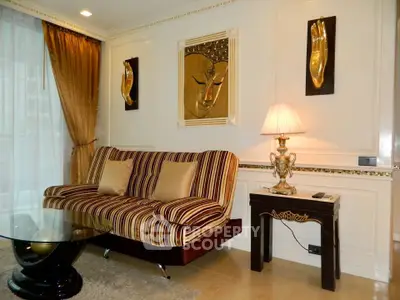 Luxurious living room with elegant decor and plush striped sofa in a sophisticated apartment.