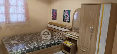 Cozy bedroom with modern wooden furniture and decorative wall art.