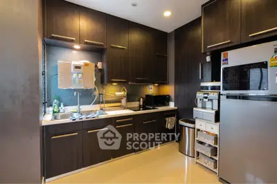 Modern kitchen with dark wood cabinets and stainless steel appliances