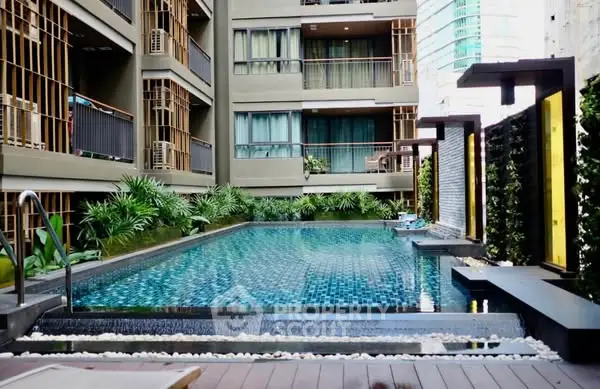 Luxurious modern apartment with stunning outdoor pool and lush greenery