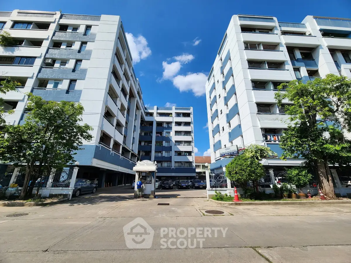 Modern apartment buildings with clear blue sky and lush greenery