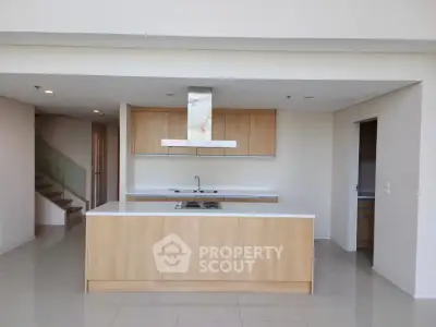 Modern kitchen with sleek cabinetry and central island in open layout