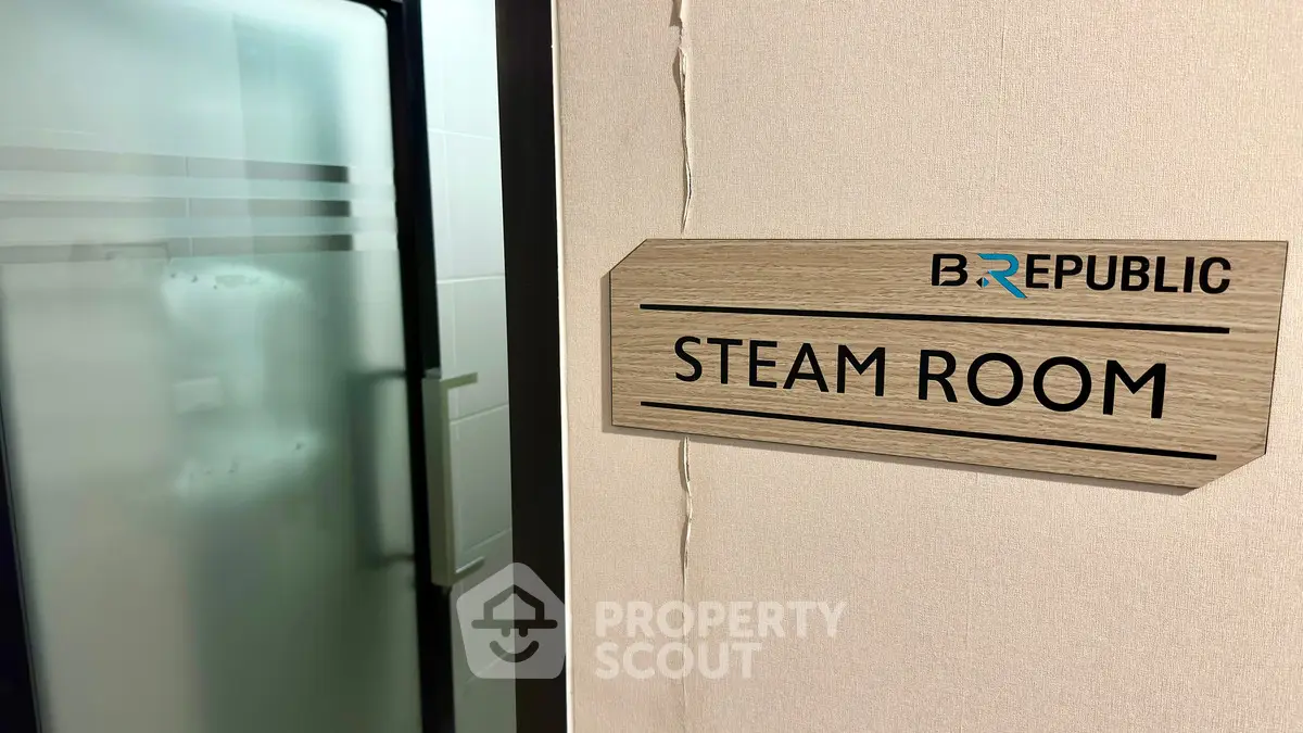 Modern steam room entrance with sleek design and branding
