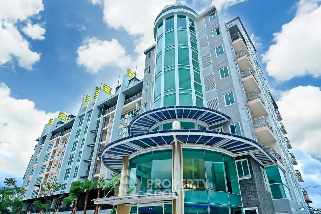 Modern high-rise building with glass facade and unique architectural design.