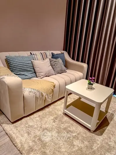 Cozy living room with plush sofa and stylish coffee table, perfect for relaxation.