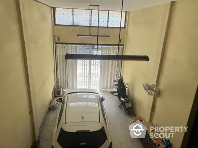 Spacious indoor parking area with car and motorbike storage