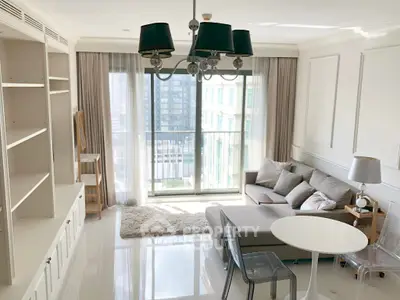 Bright and modern living room with large windows and stylish furniture in a high-rise apartment.