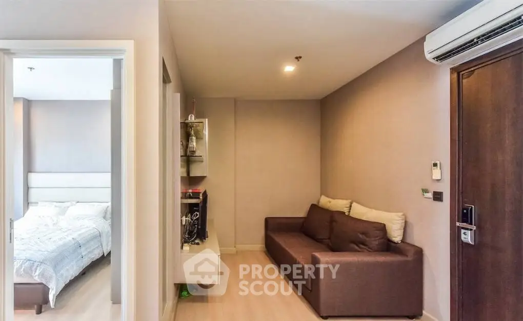 Cozy apartment interior with modern living room and bedroom, featuring stylish furniture and neutral tones.