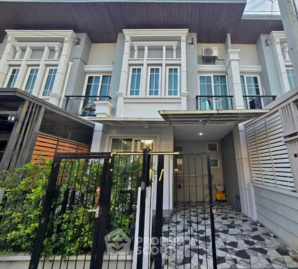 Modern townhouse exterior with gated entrance and stylish facade