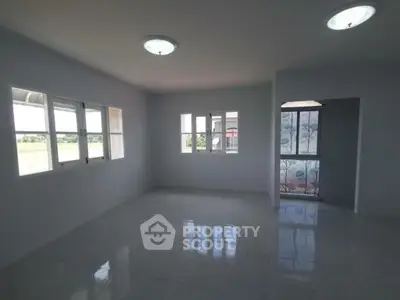 Spacious empty room with large windows and natural light
