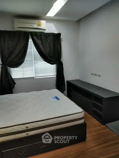 Cozy bedroom with modern furnishings and natural light