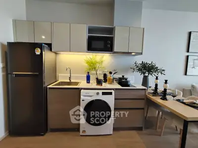 Modern kitchen with sleek cabinetry, integrated appliances, and stylish dining area.