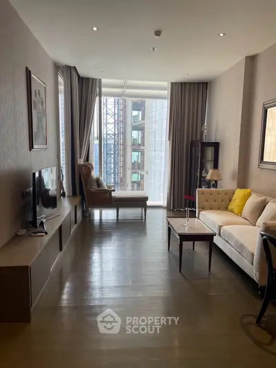 Elegant living room with modern decor and city view, featuring a cozy sofa and stylish armchair.