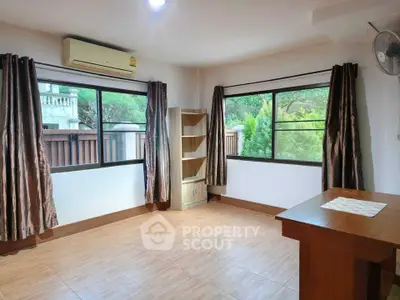 Spacious unfurnished room with large windows and garden view, perfect for customization.