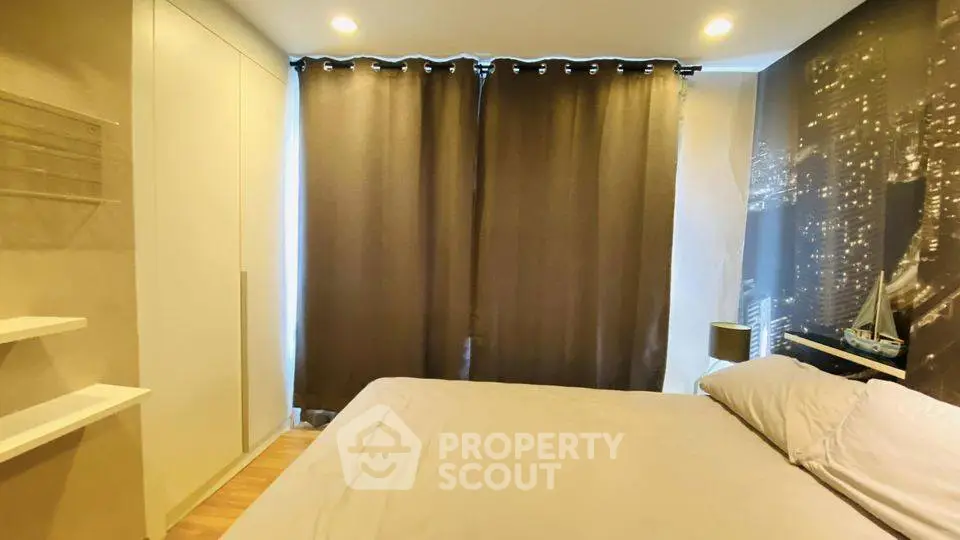 Cozy bedroom with cityscape wallpaper and modern lighting