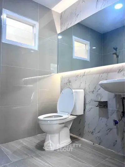 Modern bathroom with sleek gray tiles and elegant fixtures