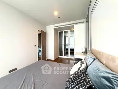 Modern bedroom with stylish decor and mirrored closet doors in a contemporary apartment.
