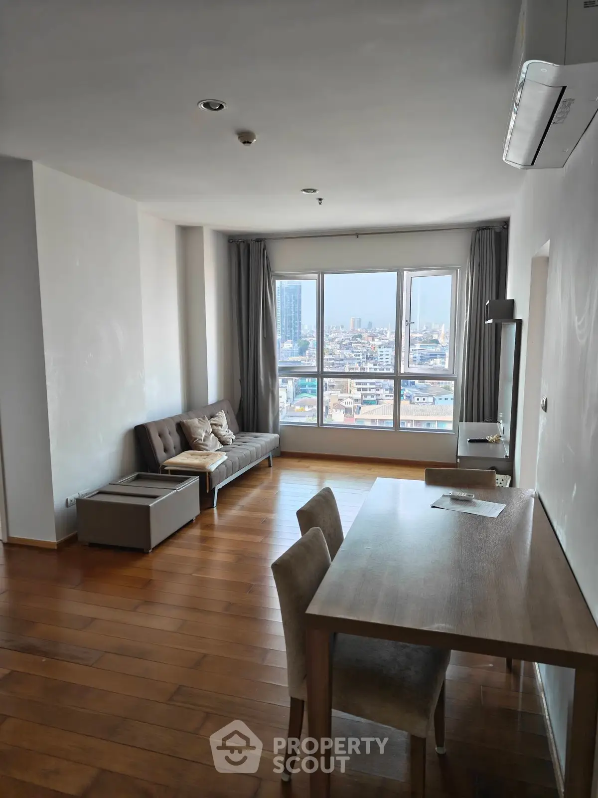 Spacious living room with city view and modern furnishings