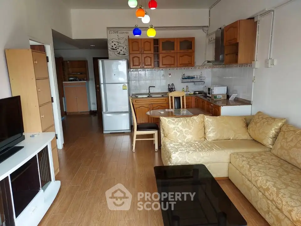 Charming open-layout living room with cozy kitchen and elegant sofa in a modern apartment.