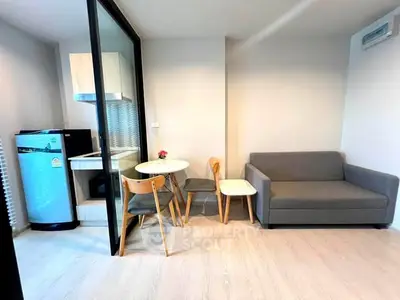 Modern compact living room with open kitchen and stylish furniture