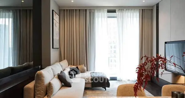 Luxurious modern living room with elegant decor and large windows.