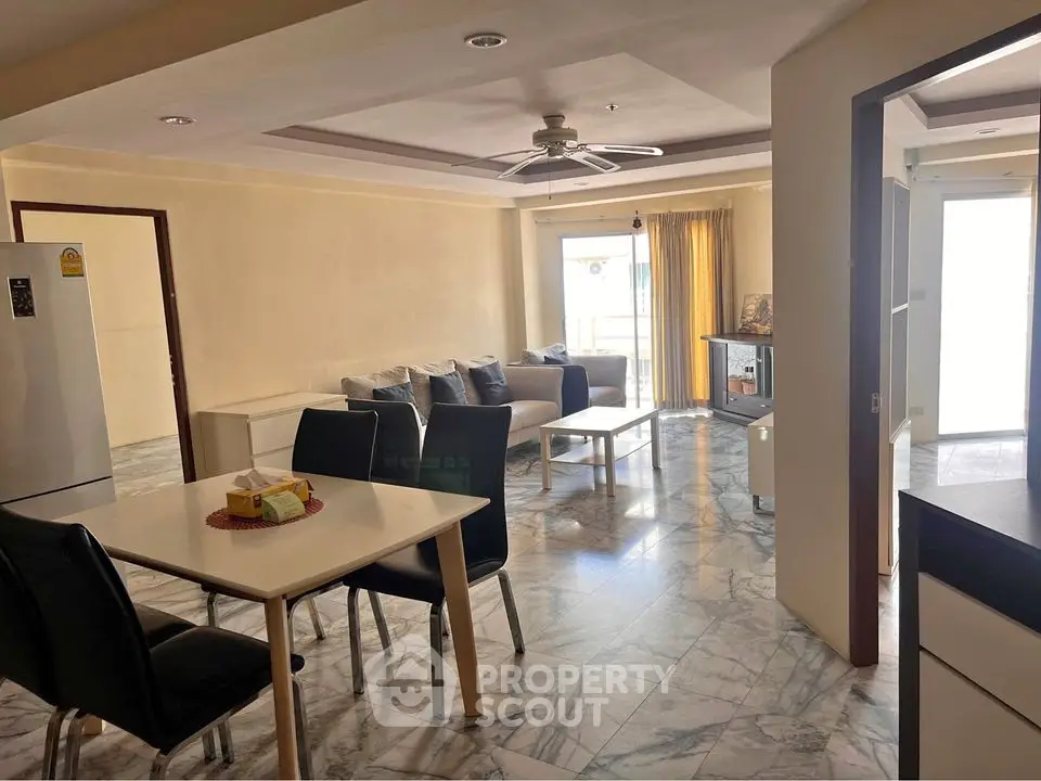 Spacious open-plan living and dining area with modern furnishings and natural light.