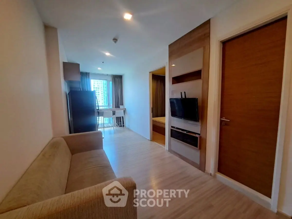 Modern apartment interior with cozy living area and bedroom view