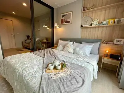 Cozy bedroom with modern decor and inviting ambiance, featuring a stylish bed and elegant lighting.