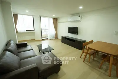 Spacious living room with modern furniture and city view, perfect for relaxation and entertainment.