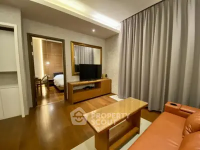 Modern living room with wooden flooring and stylish furniture in a cozy apartment.