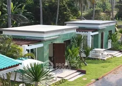 Charming modern bungalow with lush garden and outdoor seating area.