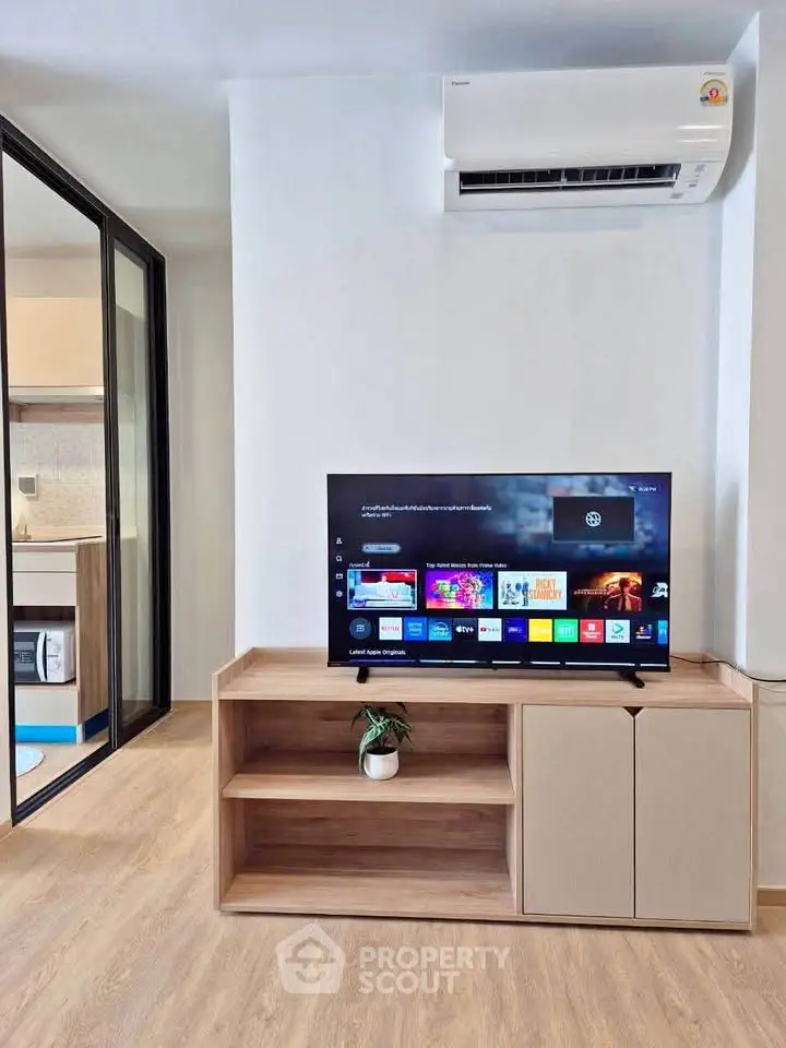 Modern living room with sleek TV setup and air conditioning unit