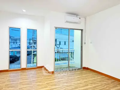 Bright and airy room with large windows and balcony access, perfect for modern living.