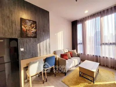 Modern living room with stylish decor and large windows offering natural light.