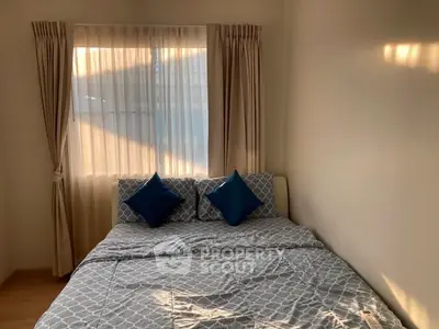 Cozy bedroom with natural light and stylish bedding