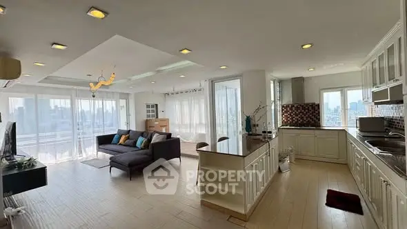 Spacious open-plan living room and kitchen with modern design and city view.