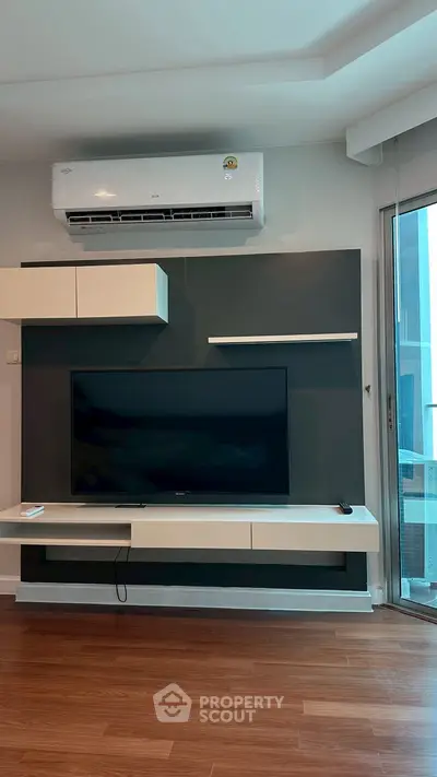 Modern living room with sleek TV setup and air conditioning