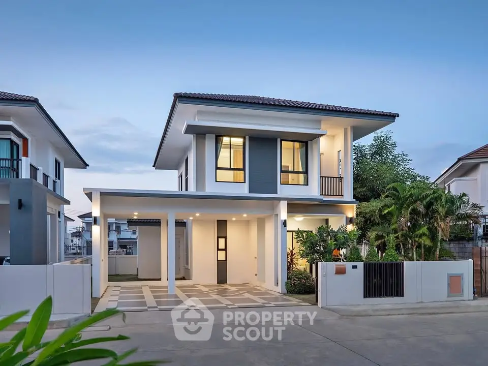 Modern two-story house with sleek design and lush greenery in a serene neighborhood.