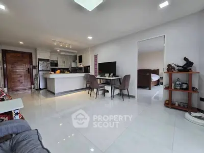 Spacious open-plan living room with modern kitchen and elegant decor