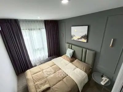 Cozy modern bedroom with elegant decor and large window for natural light.