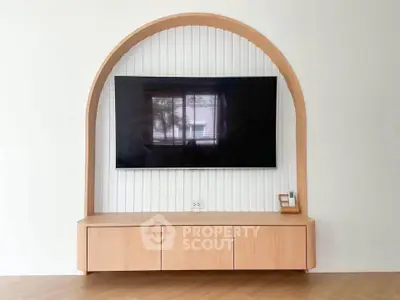 Modern living room with stylish TV setup and wooden cabinet