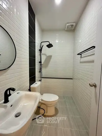 Modern bathroom with sleek black fixtures and white tile design