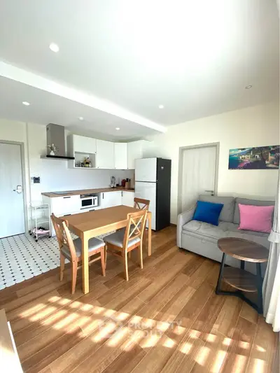 Bright modern living room with open kitchen and wooden flooring