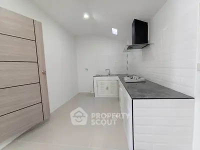 Modern minimalist kitchen with sleek cabinetry and gas stove