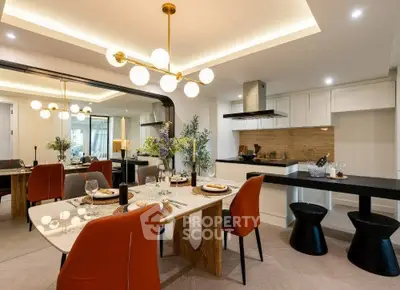 Luxurious modern dining area with elegant lighting and open kitchen layout