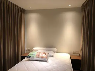 Cozy bedroom with soft lighting and elegant curtains, perfect for restful nights.