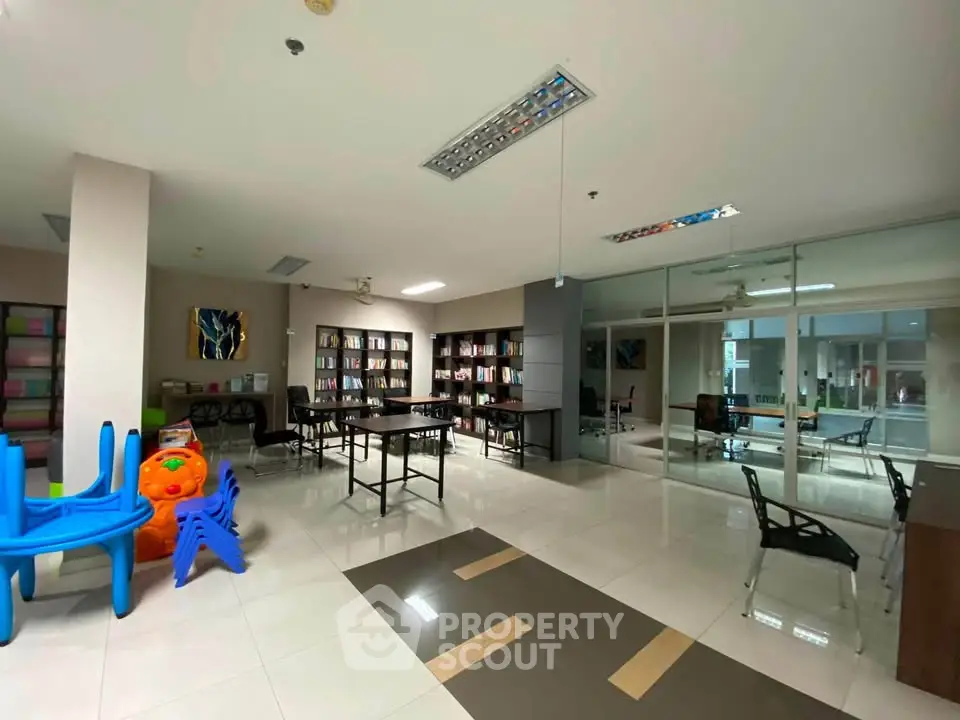 Spacious library with modern design and ample seating in a real estate property.